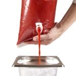 Snap-cap, pouring ketchup in a open GN-pan